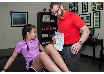 Aart Schulenklopper, PT, DPT, CMTPT - GREENSBORO PHYSICAL THERAPY - Greensboro, NC Physical Therapists - Doctor With Patient Image