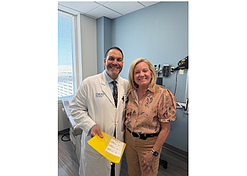 Daniel Refai, MD - Atlanta, GA Neurosurgeons - Doctor With Patient Image