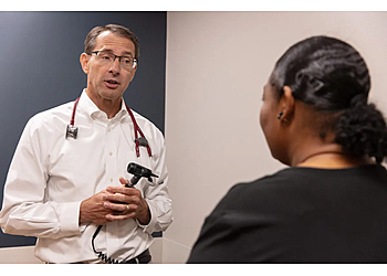David M. Keller, MD - Omaha, NE Primary Care Physicians - Doctor With Patient Image