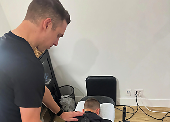 Dr. Jacob Stutz, DC, MS - Frisco, TX Chiropractors - Doctor With Patient Image