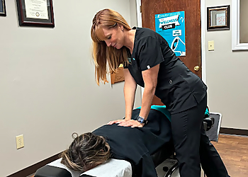 Dr. Jenifer DeWald Leber, DC - Mobile, AL Chiropractors - Doctor With Patient Image