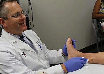 Dr. Jeremiah Graff, DPM, FACFAS, CWS - Plano, TX Podiatrists - Doctor With Patient Image