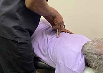 Dr. Jeremy L. Coleman, DC - Jackson, MS Chiropractors - Doctor With Patient Image