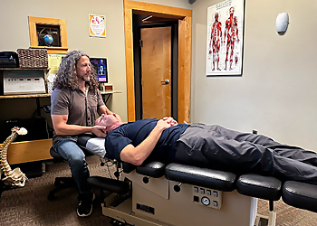 Dr. John C. Bauman, DC - Vancouver, WA Chiropractors - Doctor With Patient Image