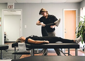 Dr. Taylor Langebartels, DC - Broken Arrow, OK Chiropractors - Doctor With Patient Image