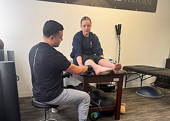 Edward Benitez, PT, DPT - OVERTIME SPORTS PHYSICAL THERAPY + PERFORMANCE - Centennial, CO Physical Therapists - Doctor Working Image