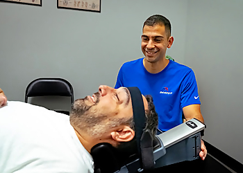 Jonathan Gonzalez, PT - REHABSPOT PHYSICAL THERAPY - Orlando, FL Physical Therapists - Doctor With Patient Image