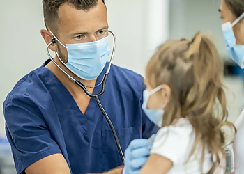 LCMC Health Urgent Care - New Orleans, LA Urgent Care Clinics - Doctor With Patient Image