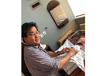 Lyndon Senar, MD - Bakersfield, CA Pediatricians - Doctor With Patient Image