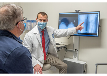 Michael A Charters, MD - Detroit, MI Orthopedics - Doctor With Patient Image