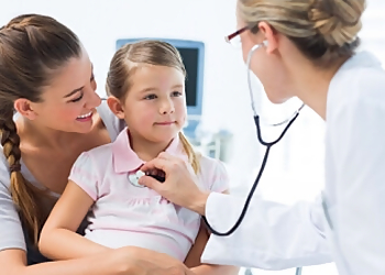Mojibola O Solaja, MD - Columbia, SC Pediatricians - Doctor With Patient Image