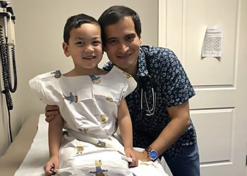 Oscar Larrazolo, MD - Lancaster, CA Pediatricians - Doctor With Patient Image