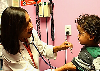 Renu Garg, MD - Houston, TX Pediatricians - Doctor With Patient Image