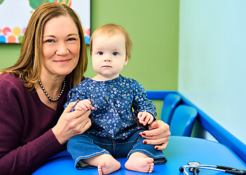Rhonda Merchant, MD - Plano, TX Pediatricians - Doctor With Patient Image