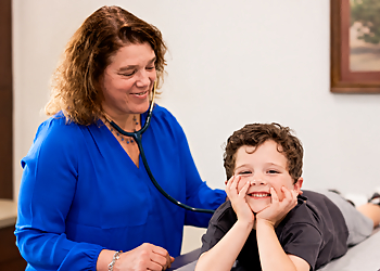 Stephanie Shults, MD, FAAP, IBCLC - Knoxville, TN Pediatricians - Doctor With Patient Image