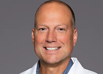 Timothy J. Hulst , DPM Timothy J. Hulst , DPM - Grand Rapids, MI Podiatrists - Doctor With Patient Image